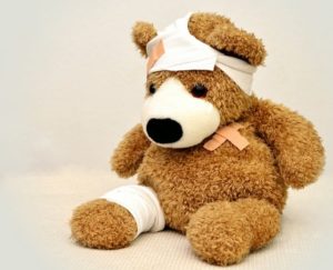 brown and with teddy bear with bandages