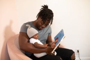 man reading to baby 