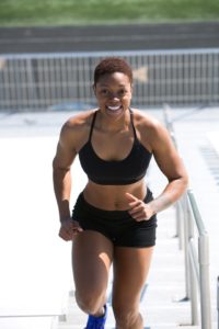 woman in black outfit doing cardio