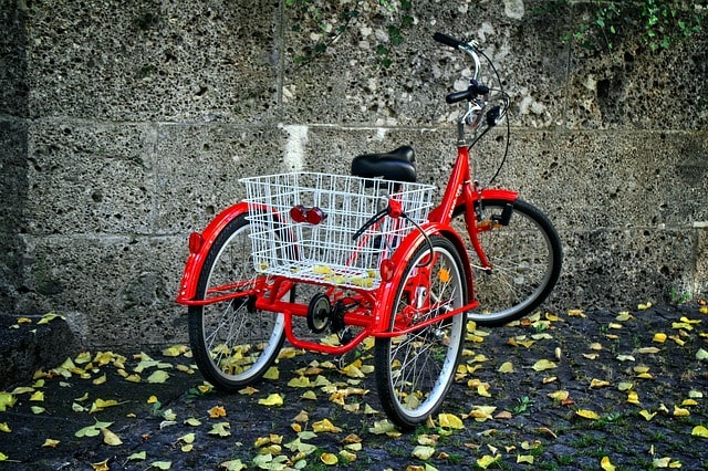 Red adult trike bike on pavement