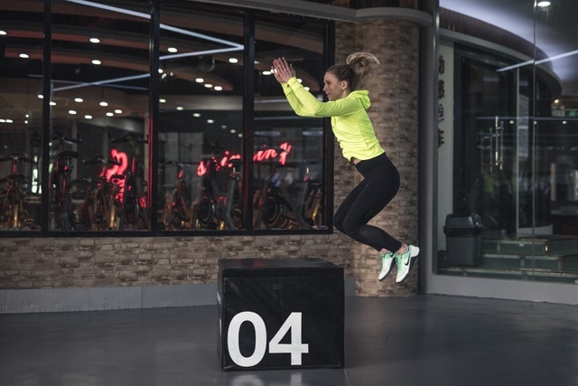 Woman performing plyometric box jump