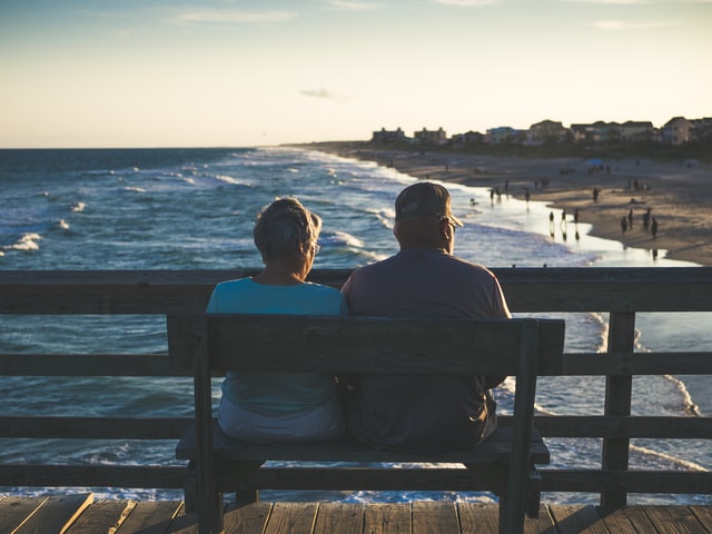 Retired couple sitting on bench