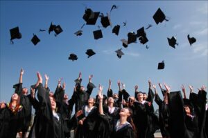 Students tossing graduation caps